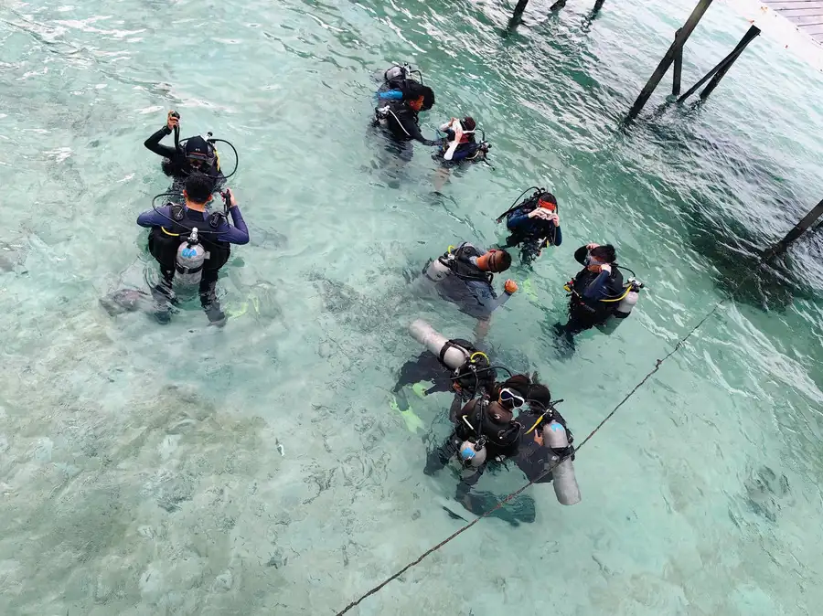 Group of scuba divers preparing for a dive in Semporna Pearl Island Resort